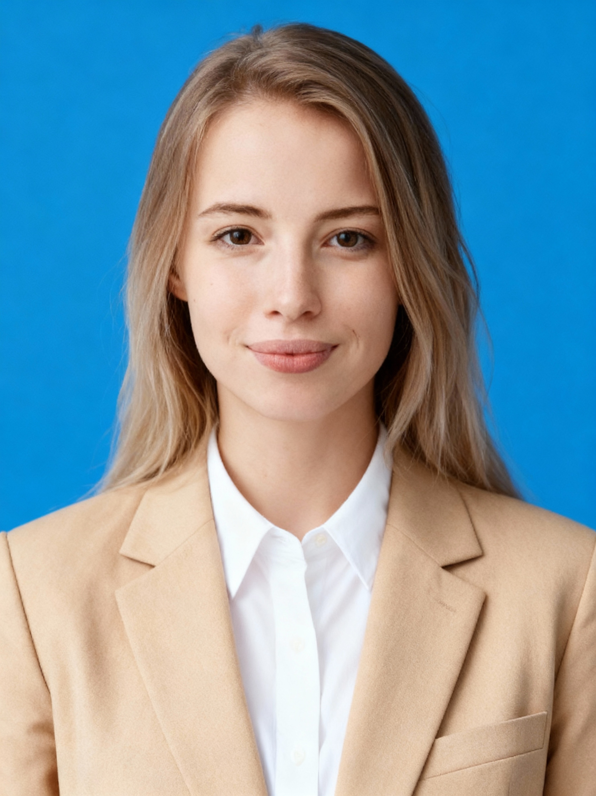 Instant headshot example wearing a tan blazer on blue background